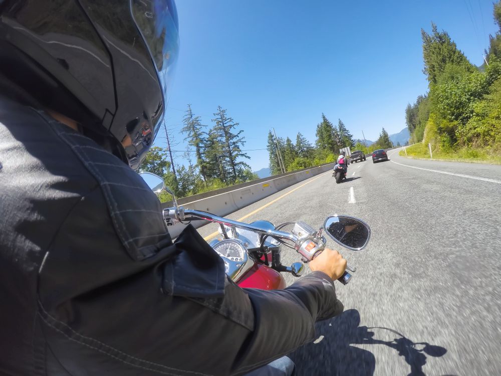 PI tailing a subject's car on motorcycle during surveillance ops