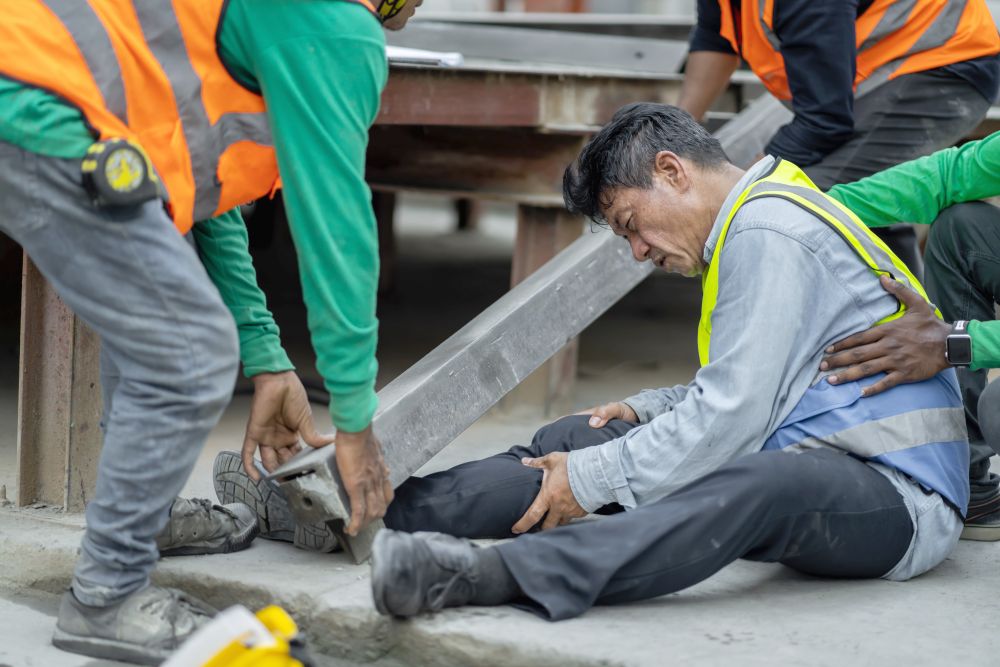 work injury at construction site where steel beam falls on workrers foot